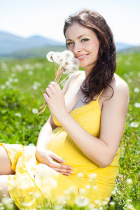 pregnant woman in field with flower